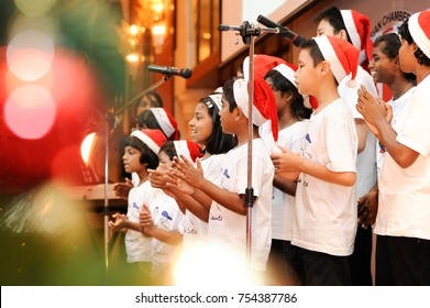 December 2016,Kuala Lumpur,Malaysia.Selective Focus On A Group Of Kids Choir Wearing Christmas  Santa Claus Hats At Christmas Dinner Party Event At A Christmas Celebration.