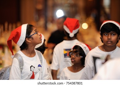 December 2016,Kuala Lumpur,Malaysia.Selective Focus On A Group Of Kids Choir Wearing Christmas  Santa Claus Hats At Christmas Dinner Party Event At A Christmas Celebration.