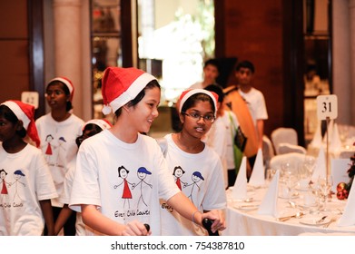 December 2016,Kuala Lumpur,Malaysia.Selective Focus On A Group Of Kids Choir Wearing Christmas  Santa Claus Hats At Christmas Dinner Party Event At A Christmas Celebration.