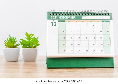 December 2021 Desk Calendar On Wooden Table.