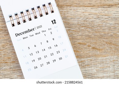 The December 2022 desk calendar on wooden background.