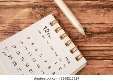 December 2023 - Closeup of a small desktop calendar with wooden table background, time and business concept - Shutterstock ID 2368213329
