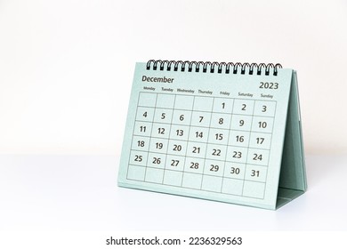 December 2023 deck calendar on white table. 