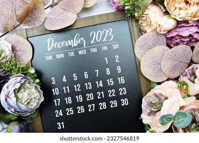 December 2023 monthly calendar with flower bouquet decoration on marble background - Shutterstock ID 2327546819