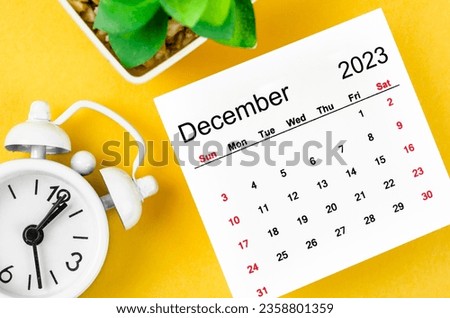 December 2023 Monthly calendar for 2023 year with alarm clock on yellow background.