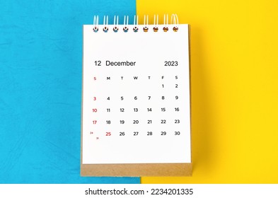 December 2023 Monthly desk calendar for 2023 year on blue and yellow background. - Shutterstock ID 2234201335