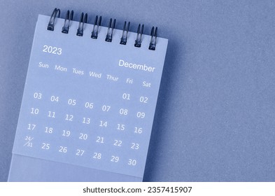 December 2023 Monthly desk calendar for 2023 year on blue background.