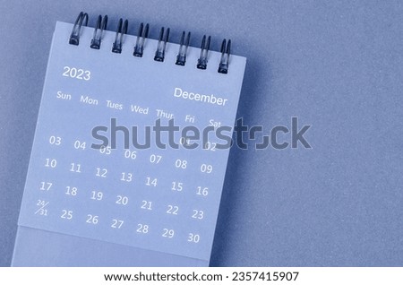 December 2023 Monthly desk calendar for 2023 year on blue background.