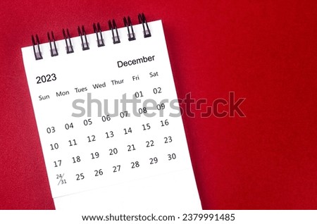 December 2023 Monthly desk calendar for 2023 year on red background.