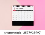 December 2024 desk calendar on pink color background.. Page of annual monthly calendar for your plan.