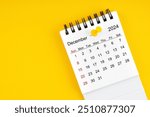 December 2024 Monthly desk calendar for 2024 year with thumbtack on yellow background.