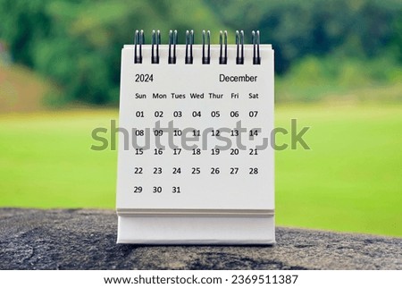 December 2024 white calendar with green blurred background. 2024 new year concept
