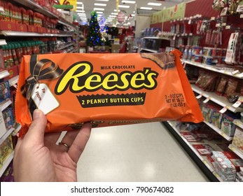 DECEMBER 24 2017 - CRYSTAL, MN: A Female Hand Holds Up A Giant Reese's Peanut Butter Cup At A Grocery Store Aisle. These Special Size Candy Bars Are Only Available During The Christmas Season 