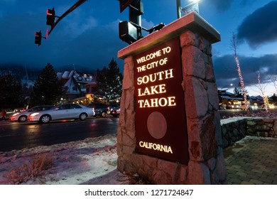 December 25, 2018 South Lake Tahoe / CA / USA - Sign Posted At The Entrance To South Lake Tahoe; The Main Street Decorated For The Christmas Holidays Visible In The Background