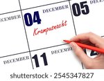 December 4. Hand writing text Krampusnacht on calendar date. Save the date. Holiday.  Day of the year concept.