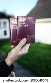 December 5, 2021, Cork, Ireland - Someone holding 2 Portuguese passports with an out of focus background
