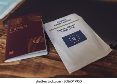 December 5, 2021, Cork, Ireland - A Portuguese passport and an EU digital covid certificate lying on a wooden table
