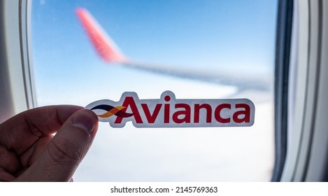 December 6, 2021, Bogota, Colombia. Emblem Of Avianca Airline Against The Backdrop Of An Airplane Window.