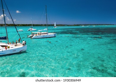 December 7, 2019, People on catamarans swim in a lagoon on the east coast of the island of Mauritius in the Indian Ocean.