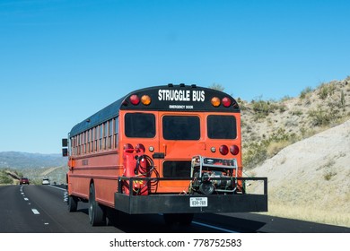 DECEMBER 9 2017 - TUSCON, AZ: A Struggle Bus Drives Down An Arizona Highway With Equipment Carried On A Trailer On A Sunny Day. 