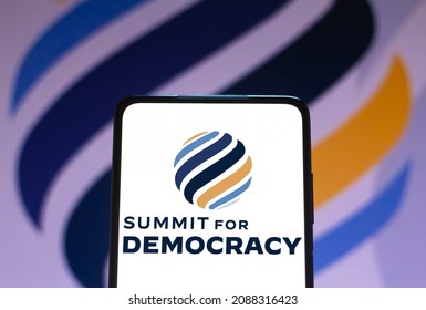 December 9, 2021, Brazil. In This Photo Illustration The Summit For Democracy Logo Seen Displayed On A Smartphone And On The Background. Is A Virtual Summit To Be Hosted By The United States