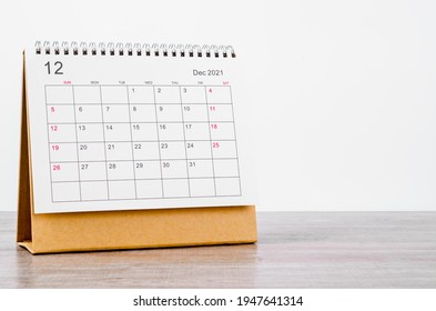 December Calendar 2021 on wooden table background.