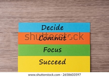 Decide, commit, focus succeed quotes on colorful paper note