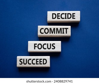 Decide Commit Focus Succeed symbol. Concept words Decide Commit Focus Succeed on wooden blocks. Beautiful deep blue background. Business concept. Copy space.