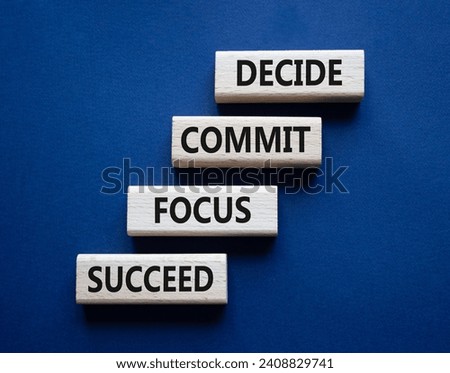Decide Commit Focus Succeed symbol. Concept words Decide Commit Focus Succeed on wooden blocks. Beautiful deep blue background. Business concept. Copy space.