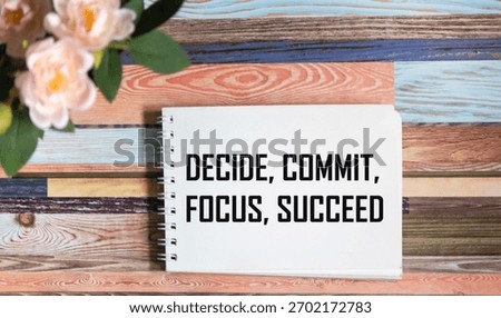 The Decide commit focus symbol for successful implementation. The conceptual word Decide Commit Focus for successful implementation on notepad