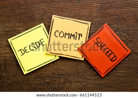 Decide, commit, succeed motivational word abstract on colorful sticky notes against rustic wood