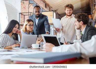 Deciding. Diverse Group Of Co-workers Having Casual Discussion In Office. Executives During Friendly Discussion, Month Reporting, Creative Meeting. Concept Of Business, Finance, Occupation, Job.