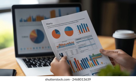 Deciphering Financial Fortunes: Hands Engaged with Graphs and Charts on Office Desk Landscape
