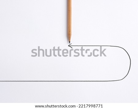 Decision to change direction in business, finance, career or education concept. Decision to renounce or retract. Pencil draws a turning point arrow line on white background.