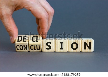 Decision or conclusion symbol. Businessman turns wooden cubes and changes the word 'conclusion' to 'decision'. Beautiful grey background. Business, decision or conclusion concept. Copy space.