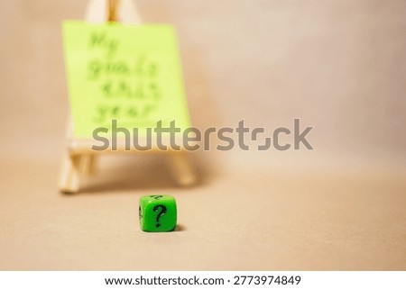 Decision making concept with question mark cube and blurred goals background. Uncertainty and choice.