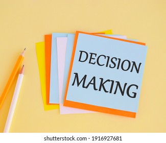 Decision making handwritten on a colofrful sticker. Concept of the action or process of making important decisions