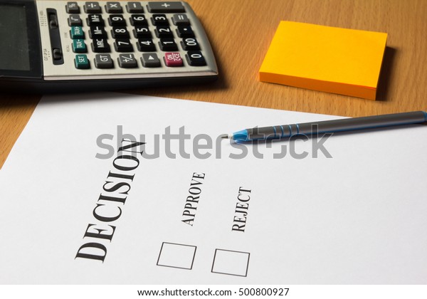 Decision paper (approve, reject) with pen,\
calculator, note