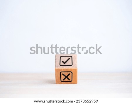 Decision, right or wrong choosing, positive or negative, yes or no concepts. Checkmark and cross x icon symbol in check box on flipping wooden cube block isolated on white background with copy space.