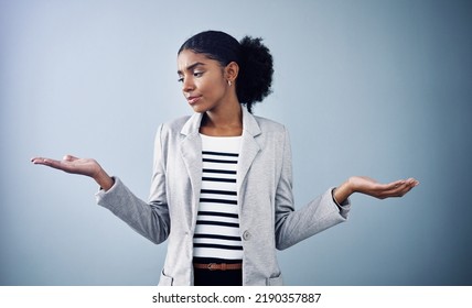 Decisions, Choices And Options With A Young Business Woman Comparing And Weighing Up Different Decisions With Copyspace In Studio Against A Grey Background. Picking Between Two Balanced Ideas