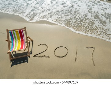 Deck chair with 2017 written in sand write on tropical beach. - Powered by Shutterstock