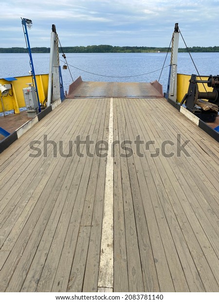 deck on a barge\
without people, ferry for transporting people and cars across the\
river, forward view, no\
one