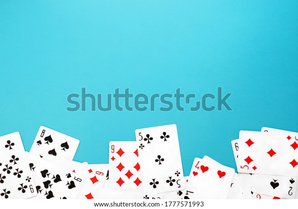 Deck of\
playing cards on blue background copy\
space