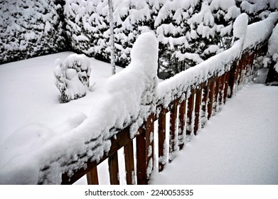 deck post covered in snow, snow falling, snow covered deck railing, winter season, side view - Shutterstock ID 2240053535
