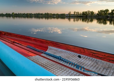 Deck Of A Racing Stand Up Paddleboard With A Safety Leash On A Calm Lake At Sunset.