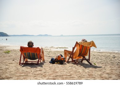 Deckchair, chair on the beach in sunshine day. Empty colorful wooden beach chair on tropical beach with blue sky background in vintage retro tone. To represent the meaning of summer vacation time. - Powered by Shutterstock