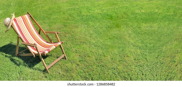 deckchair on greenery grass in a garden in panoramic size