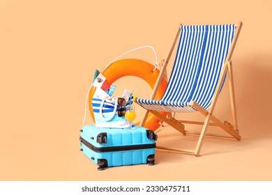 Deckchair with suitcase, ring buoy and beach accessories on beige background. Travel concept - Powered by Shutterstock