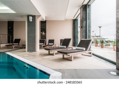 deckchairs near indoors swimming pool
