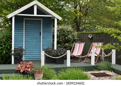 Deckchairs And Wooden Garden Shed In A Garden Near Barnsdale, UK